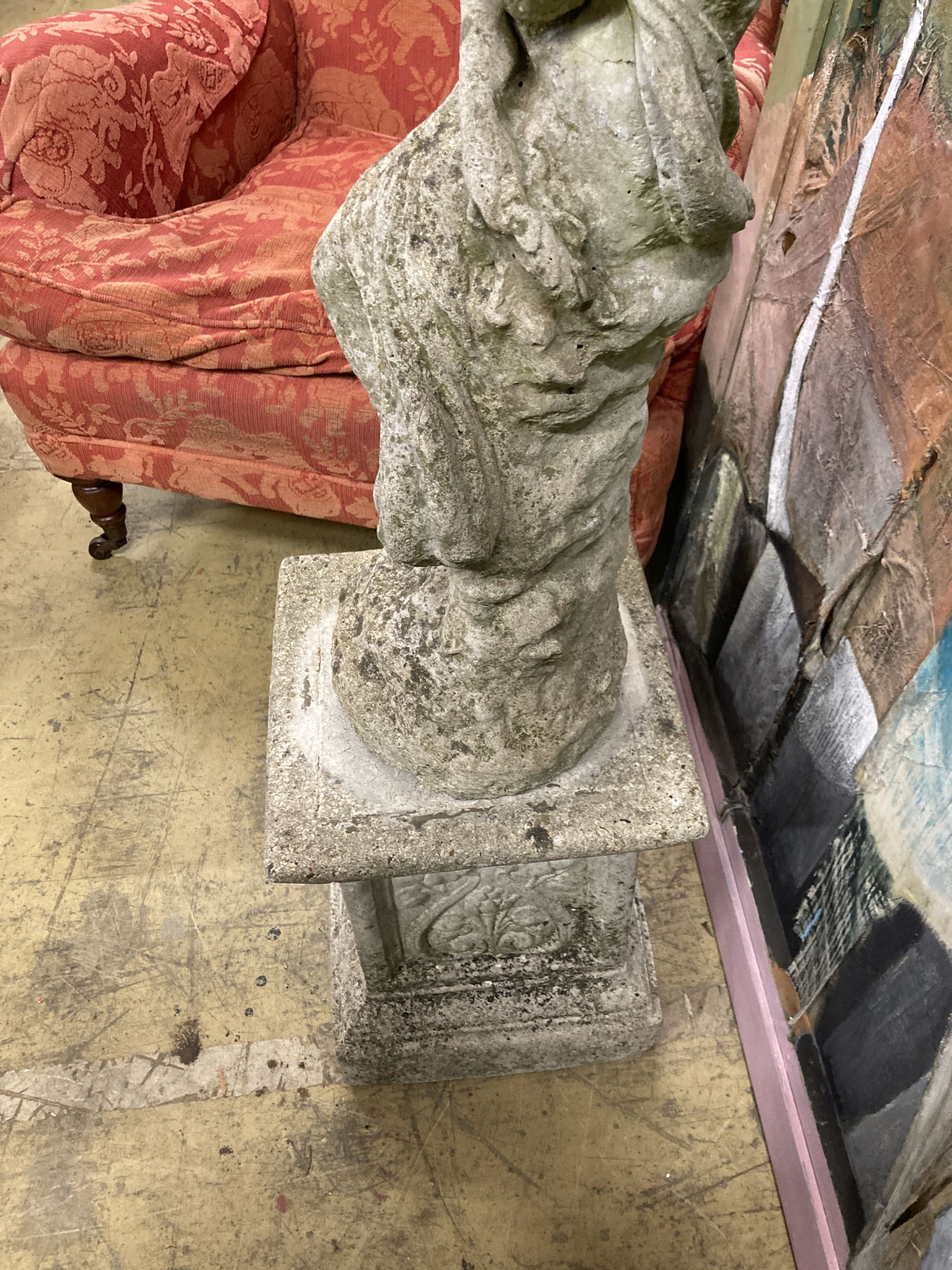 Two reconstituted stone figural garden ornaments on stands, larger 128cm high